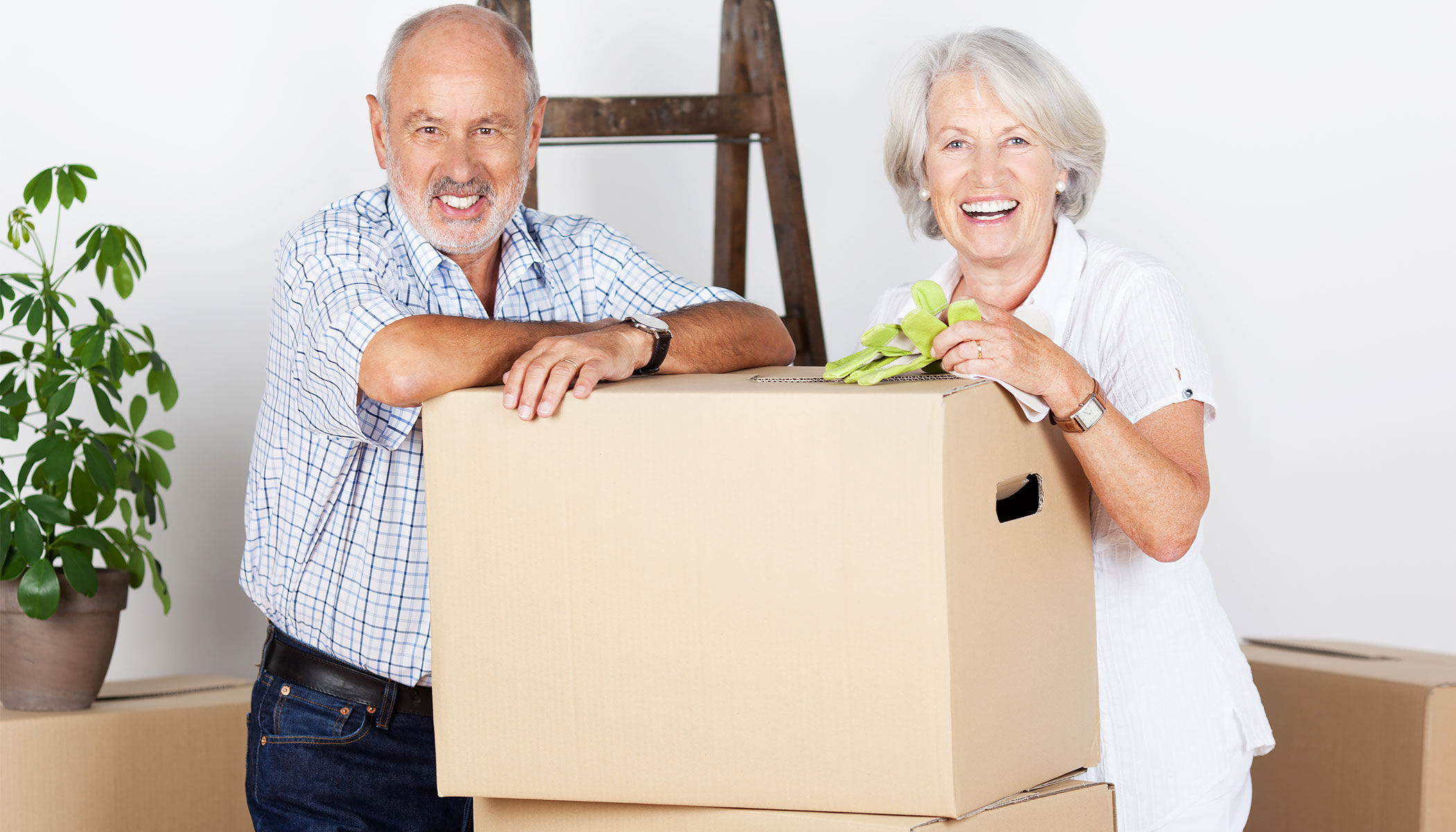 Retired couple packing for a move while downsizing their home