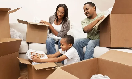 Family unpacking moving boxes after a move