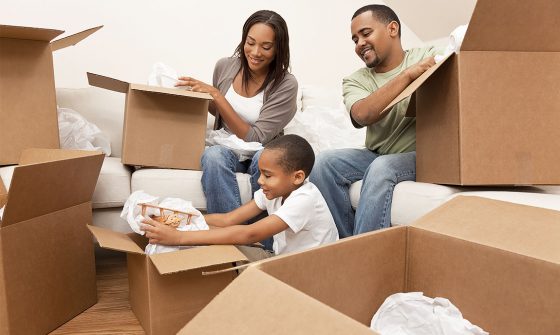 Family unpacking moving boxes after a move