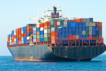 Cargo ship transporting shipping containers on ocean
