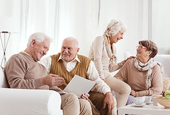 Two couples living in a retirement, senior living community