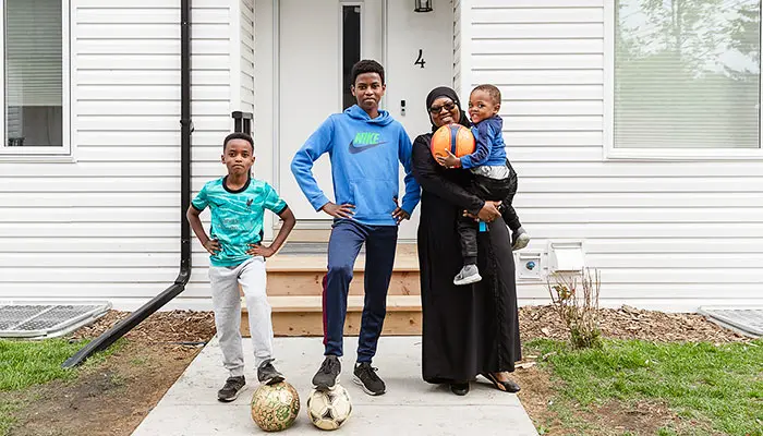 Habitat for Humanity Canada Family in front of their new home