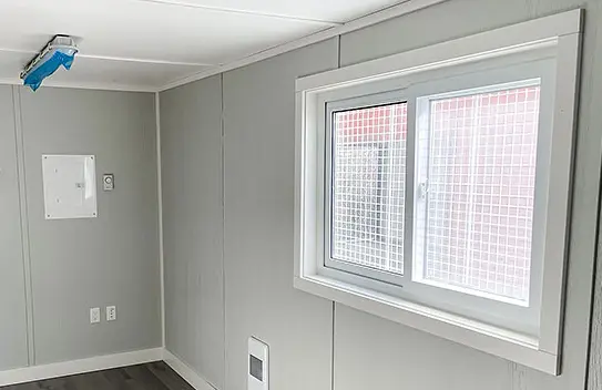Interior of a modified shipping container with windows - BigSteelBox