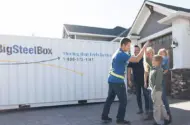 Family with a BigSteelBox moving and storage container in their driveway